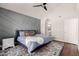 Stylish bedroom includes an accent wall, plush rug, and large windows for tons of natural light at 6520 E Sugarloaf St, Mesa, AZ 85215
