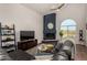 Bright living room with a corner fireplace, vaulted ceiling, and comfortable seating area at 6520 E Sugarloaf St, Mesa, AZ 85215