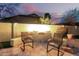 Backyard with pavers, seating around a firepit, and block wall at 69 E Benrich Dr, Gilbert, AZ 85295