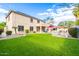 A large yard features artificial turf, professional landscaping, and a built-in kitchen with a pool at 69 E Benrich Dr, Gilbert, AZ 85295