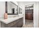 Bathroom vanity with granite counters, framed mirrors, and a view into the large walk-in closet at 69 E Benrich Dr, Gilbert, AZ 85295