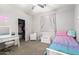 Bright bedroom with carpet floors, a cute bed, a vanity desk, and a closet at 69 E Benrich Dr, Gilbert, AZ 85295