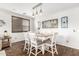 Bright dining room with wood-look flooring, natural lighting, and a charming dining set at 69 E Benrich Dr, Gilbert, AZ 85295
