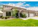 Charming stucco home with manicured lawn, dark trim, and desert landscaping at 69 E Benrich Dr, Gilbert, AZ 85295