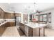 Open-concept kitchen with granite countertops, stainless steel appliances, and a breakfast nook at 69 E Benrich Dr, Gilbert, AZ 85295