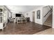 Open-concept living room with wood floors, staircase, and neutral decor at 69 E Benrich Dr, Gilbert, AZ 85295