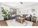 Cozy living room featuring plush seating, decorative throw pillows, and a large area rug at 69 E Benrich Dr, Gilbert, AZ 85295