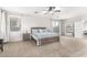 Bright main bedroom with a king bed, carpet flooring, an attached bathroom, and a sliding glass door at 69 E Benrich Dr, Gilbert, AZ 85295