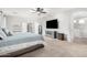Spacious main bedroom featuring a ceiling fan, TV, and ensuite bathroom with a large closet at 69 E Benrich Dr, Gilbert, AZ 85295