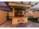 Custom outdoor kitchen with stone accents, a built-in grill, and a mosaic design of palm trees at 69 E Benrich Dr, Gilbert, AZ 85295