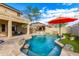 Inviting backyard pool with a waterfall feature and covered patio seating, ideal for entertaining at 69 E Benrich Dr, Gilbert, AZ 85295