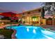 Backyard featuring a pool, shaded seating areas, and lush landscaping perfect for entertaining at 69 E Benrich Dr, Gilbert, AZ 85295