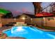 Backyard pool with travertine coping, rock waterfall features, and a block wall at 69 E Benrich Dr, Gilbert, AZ 85295