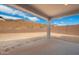 Spacious, undeveloped backyard with a covered patio, block wall fencing, and a mountain view in the distance at 6980 W Hedge Hog Pl, Peoria, AZ 85383
