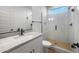 Modern bathroom with marble countertop, glass-enclosed shower and stylish fixtures at 6980 W Hedge Hog Pl, Peoria, AZ 85383