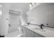 Bright bathroom featuring double sinks, modern fixtures, and a separate tub at 6980 W Hedge Hog Pl, Peoria, AZ 85383
