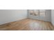 A spacious bedroom features three windows, providing natural light and hardwood-style flooring at 6980 W Hedge Hog Pl, Peoria, AZ 85383