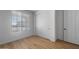Bright bedroom featuring wood-look floors, a large window and a closet with sliding doors at 6980 W Hedge Hog Pl, Peoria, AZ 85383