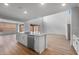 Open concept kitchen featuring an island with a sink, dishwasher and white cabinets with hardwood-style flooring at 6980 W Hedge Hog Pl, Peoria, AZ 85383