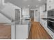 Spacious kitchen featuring a large marble island, white cabinetry, and stainless steel appliances at 6980 W Hedge Hog Pl, Peoria, AZ 85383
