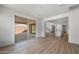 Open-concept living room leading into the kitchen, with wood-style flooring and sliding glass doors at 6980 W Hedge Hog Pl, Peoria, AZ 85383