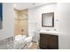 Bathroom with a granite counter, shower with decorative tile and vanity at 8201 E Piccadilly Rd, Scottsdale, AZ 85251