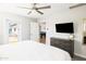 Well-lit bedroom with backyard access, a TV, and glimpses of a game room, providing comfort and entertainment at 8201 E Piccadilly Rd, Scottsdale, AZ 85251