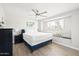 Comfortable bedroom features a window seat, ceiling fan, and wood-look floors at 8201 E Piccadilly Rd, Scottsdale, AZ 85251