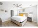 Bright bedroom featuring a ceiling fan, neutral walls, and wood-look tile flooring, creating a serene atmosphere at 8201 E Piccadilly Rd, Scottsdale, AZ 85251