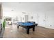Spacious living room with hardwood floors, a pool table, and easy access to the kitchen at 8201 E Piccadilly Rd, Scottsdale, AZ 85251