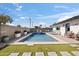 Backyard oasis featuring a sparkling pool, lush turf, and comfortable seating, creating a perfect retreat at 8201 E Piccadilly Rd, Scottsdale, AZ 85251