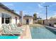 Inviting backyard with a pool, lounging chairs, and a charming patio area perfect for relaxation at 8201 E Piccadilly Rd, Scottsdale, AZ 85251