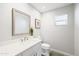 Bright half bathroom with a modern vanity, fixtures, and natural light at 8201 E Piccadilly Rd, Scottsdale, AZ 85251