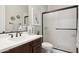 Chic bathroom featuring a dark wood vanity, white countertop, modern fixtures, and a glass-enclosed shower at 937 W Glacier Dr, Chandler, AZ 85248