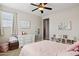 Bright bedroom featuring a white dresser, stylish decor, and a comfortable bed with pink bedding at 937 W Glacier Dr, Chandler, AZ 85248