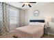 Cozy bedroom with a ceiling fan, stylish curtains, and elegant decor creating a comfortable and inviting space at 937 W Glacier Dr, Chandler, AZ 85248