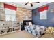 bedroom with wood wall decor, fan, white shelving, and blue walls to provide a space for sleep and fun at 937 W Glacier Dr, Chandler, AZ 85248