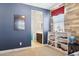 bedroom with view to bathroom, wood accent wall, blue walls, and white shelving, to provide rest and fun at 937 W Glacier Dr, Chandler, AZ 85248