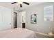 Cozy bedroom with wood wall decor, fan, and a view of the bathroom from the bedroom, creating a private retreat at 937 W Glacier Dr, Chandler, AZ 85248