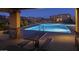 Community pool at night showcasing a picnic table, lounge chairs, and manicured landscaping at 937 W Glacier Dr, Chandler, AZ 85248