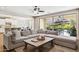 Spacious living room with a large sectional sofa, backyard views, and an open-concept layout at 937 W Glacier Dr, Chandler, AZ 85248