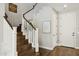 Elegant staircase with wood treads, white risers, and a beautifully adorned entry at 937 W Glacier Dr, Chandler, AZ 85248
