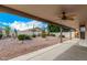 The backyard features a covered patio, desert landscaping, and stunning blue skies at 9715 E Osage Ave, Mesa, AZ 85212