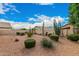 Spacious backyard features beautiful desert landscaping, rocks, and privacy walls at 9715 E Osage Ave, Mesa, AZ 85212