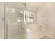Bathroom showcasing a shower with glass door and separate soaking tub under a window at 9715 E Osage Ave, Mesa, AZ 85212
