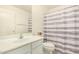 Bright bathroom featuring a modern vanity and striped shower curtain at 9715 E Osage Ave, Mesa, AZ 85212