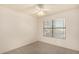 Bedroom featuring neutral carpeting, a ceiling fan, and window views of the outdoors at 9715 E Osage Ave, Mesa, AZ 85212