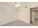 Bedroom featuring neutral carpeting, a ceiling fan, and access to the closet and hall at 9715 E Osage Ave, Mesa, AZ 85212