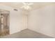 Bedroom with neutral carpeting, double door closet, and hall access at 9715 E Osage Ave, Mesa, AZ 85212