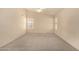 Bedroom features neutral carpeting, vaulted ceilings, a ceiling fan, and natural light from several windows at 9715 E Osage Ave, Mesa, AZ 85212